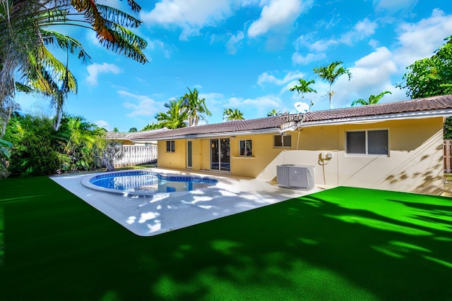 5801 NE 17th Ave, Fort Lauderdale, FL 33334 - back of house with cooling unit, stucco siding, a patio, fence, and an outdoor pool