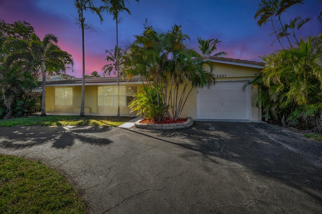5801 NE 17th Ave, Fort Lauderdale, FL 33334 - view of front of property featuring an attached garage, driveway, stucco siding, and a tile roof