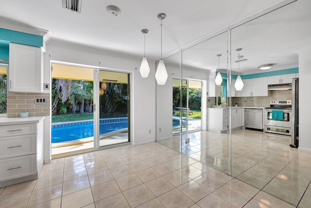 5801 NE 17th Ave, Fort Lauderdale, FL 33334 - interior space featuring ornamental molding, visible vents, appliances with stainless steel finishes, under cabinet range hood, and decorative backsplash