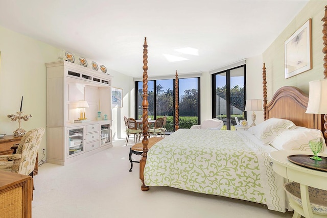 carpeted bedroom featuring access to outside and a wall of windows