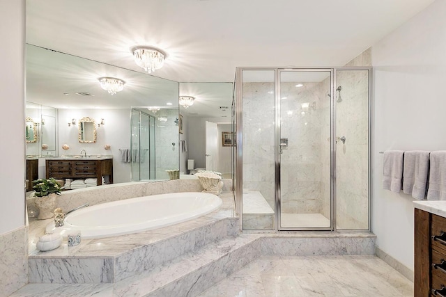 bathroom with vanity and separate shower and tub