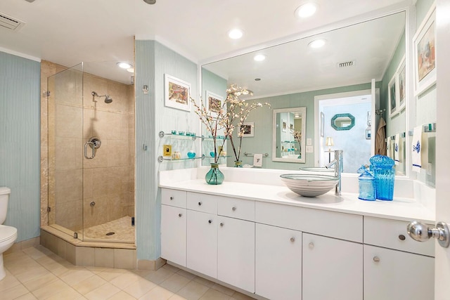 bathroom with tile patterned floors, vanity, toilet, and a shower with door