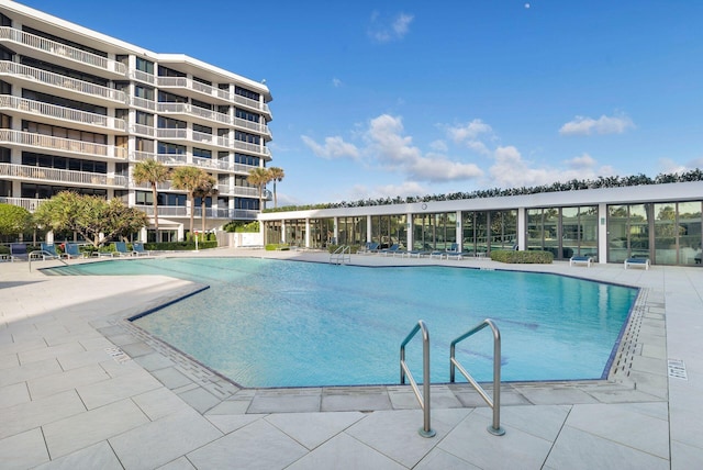 view of swimming pool with a patio area