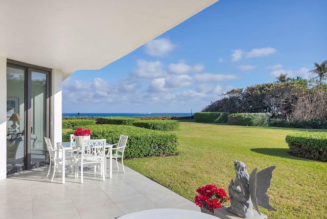 view of yard with a water view and a patio