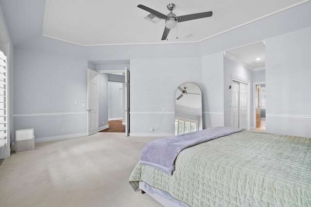 bedroom featuring ornamental molding, a closet, ceiling fan, and carpet