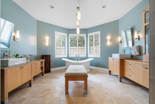 bathroom featuring vanity, a bathtub, and plenty of natural light