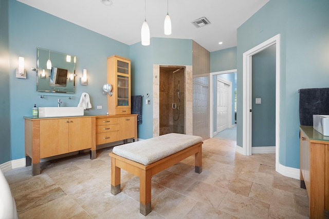 bathroom featuring vanity and tiled shower