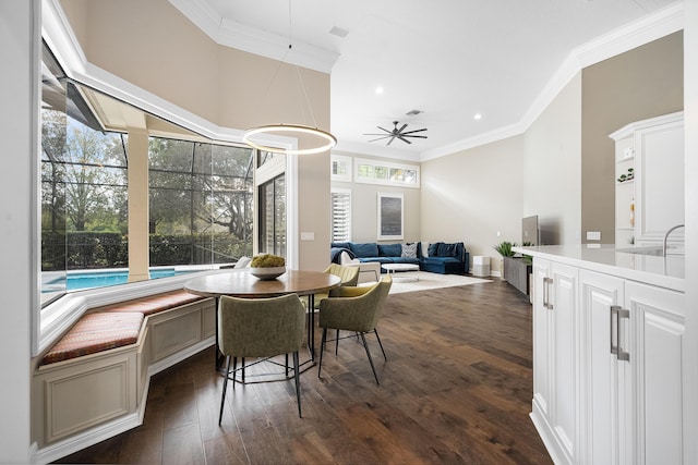 dining room featuring ornamental molding, dark hardwood / wood-style floors, and ceiling fan