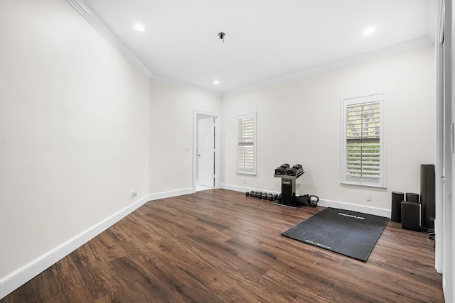 exercise area featuring dark wood-type flooring and ornamental molding