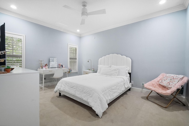 bedroom with ornamental molding, light colored carpet, and ceiling fan