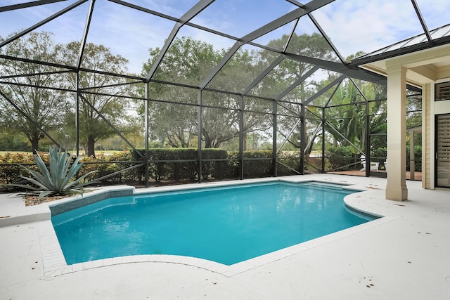 view of swimming pool featuring a lanai and a patio