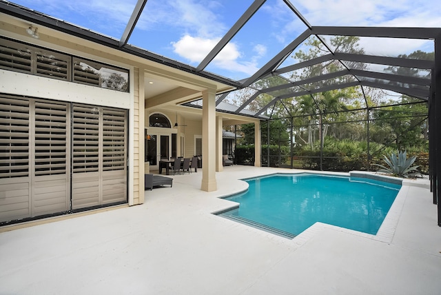 view of pool featuring ceiling fan, a patio area, and glass enclosure