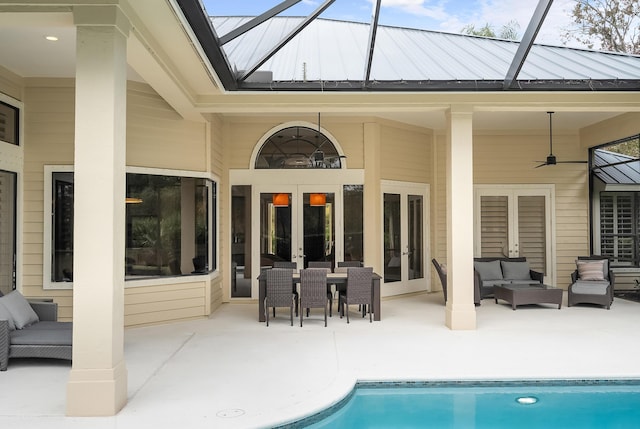 back of house with french doors, a patio area, a lanai, ceiling fan, and an outdoor living space