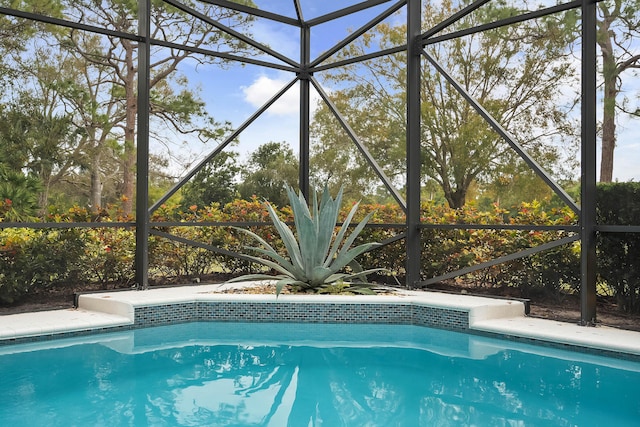 view of pool with glass enclosure