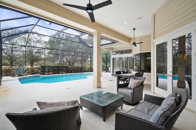 view of pool with a patio, an outdoor hangout area, ceiling fan, glass enclosure, and a mountain view