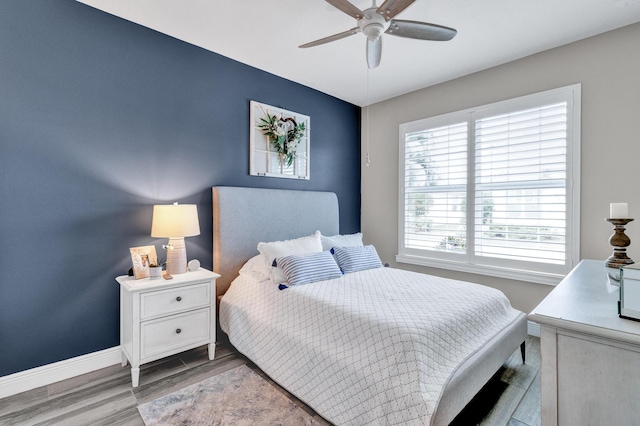 bedroom with light hardwood / wood-style floors and ceiling fan