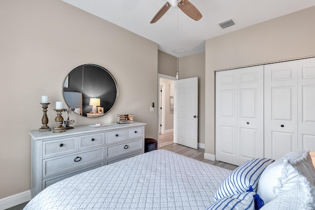 bedroom featuring ceiling fan, a closet, and light hardwood / wood-style flooring