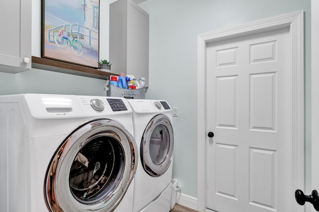 laundry area with cabinets and washing machine and dryer