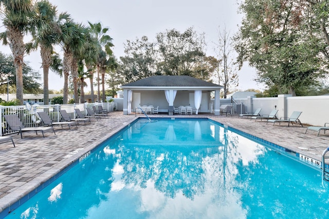 view of swimming pool featuring an outdoor structure and a patio area