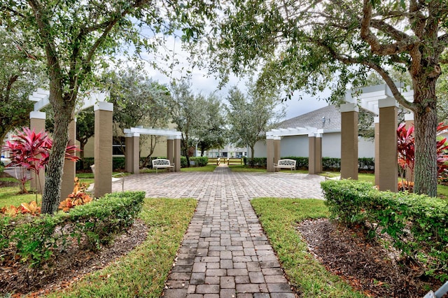 view of property's community with a pergola and a patio area