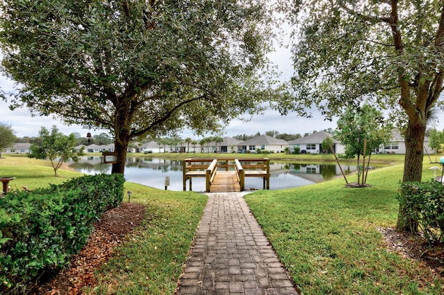 view of dock featuring a yard and a water view