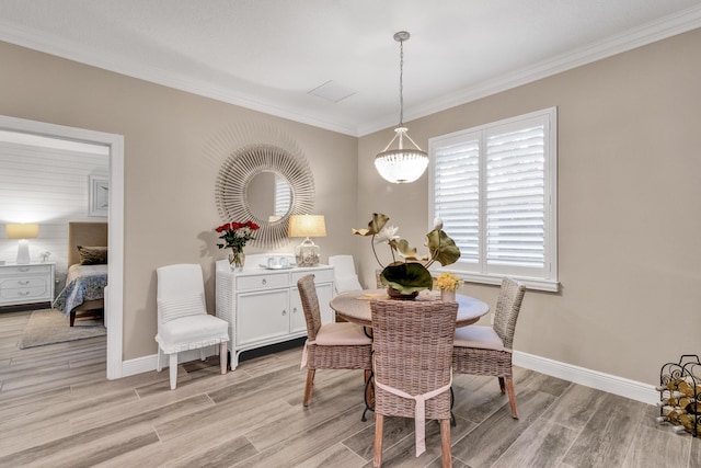 dining room featuring ornamental molding and light wood-type flooring