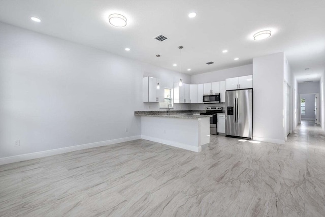 kitchen with white cabinetry, hanging light fixtures, dark stone countertops, kitchen peninsula, and stainless steel appliances