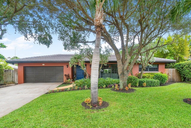 ranch-style home with a garage and a front yard