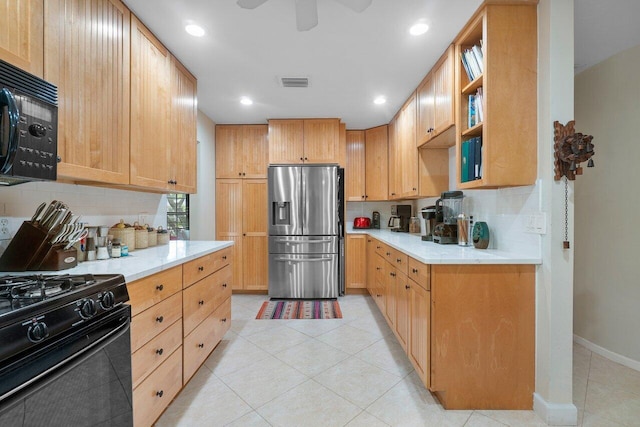 kitchen with light tile patterned flooring, light brown cabinetry, ceiling fan, decorative backsplash, and black appliances