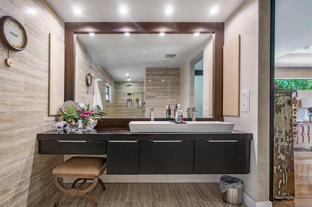 bathroom with vanity and a shower