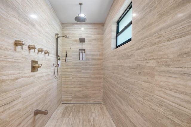 bathroom with a tile shower