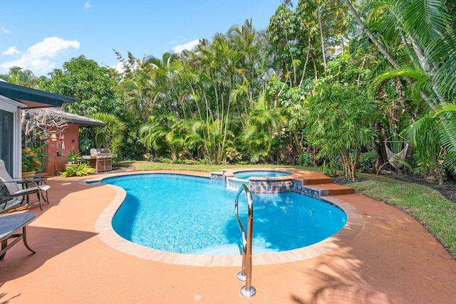 view of swimming pool with an in ground hot tub, grilling area, and a patio