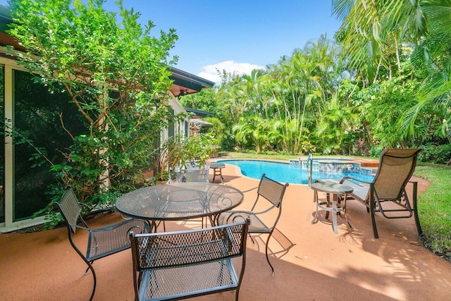 view of pool with a patio and an in ground hot tub