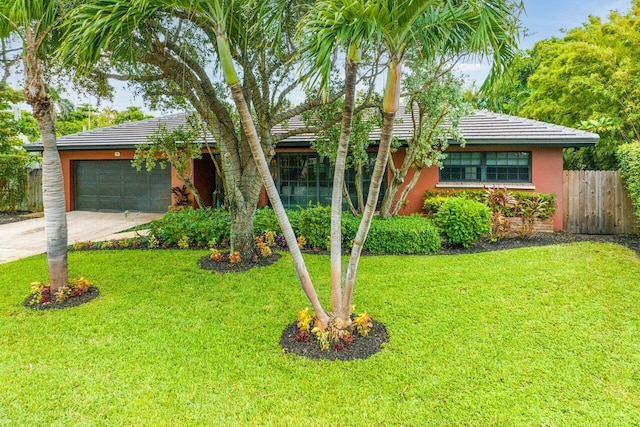 view of front of house with a garage and a front yard