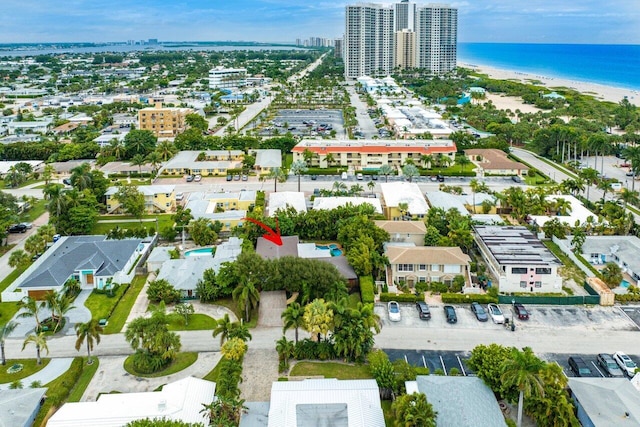 drone / aerial view featuring a beach view and a water view