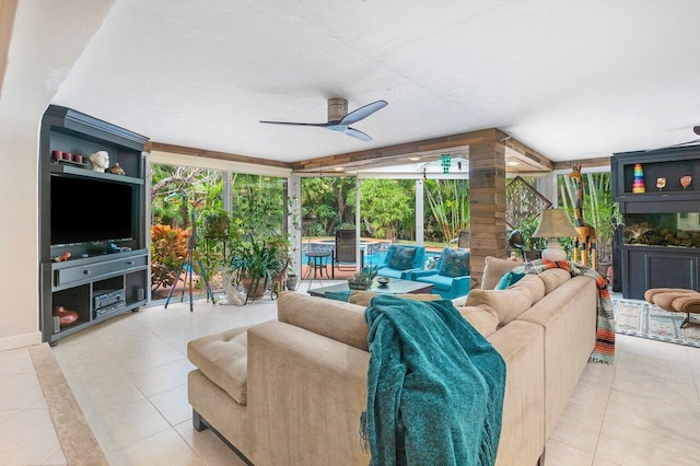 tiled living room featuring ceiling fan