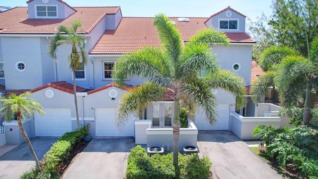 mediterranean / spanish house featuring a garage