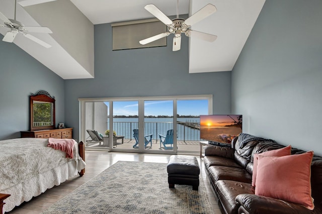 bedroom featuring ceiling fan, wood-type flooring, access to exterior, and high vaulted ceiling