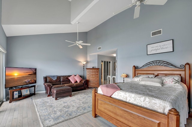 bedroom with ceiling fan, high vaulted ceiling, and light wood-type flooring