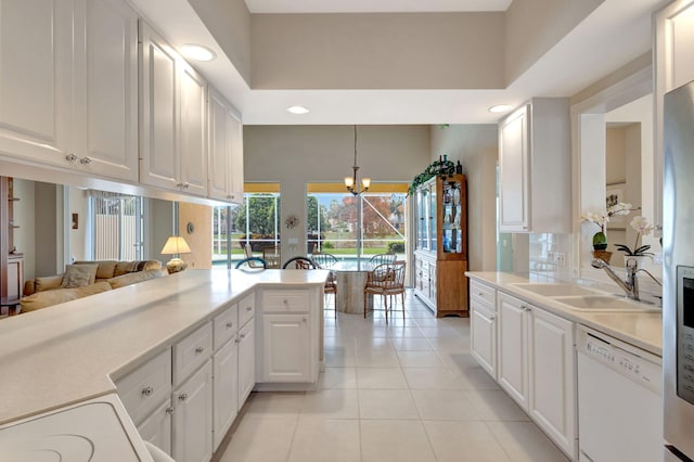 kitchen featuring light tile patterned flooring, pendant lighting, white cabinetry, white dishwasher, and kitchen peninsula