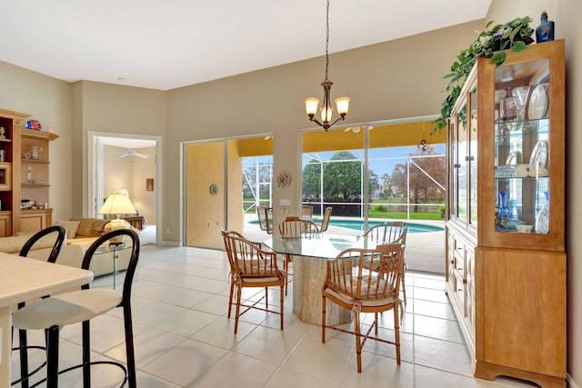 dining space featuring ceiling fan with notable chandelier and light tile patterned floors