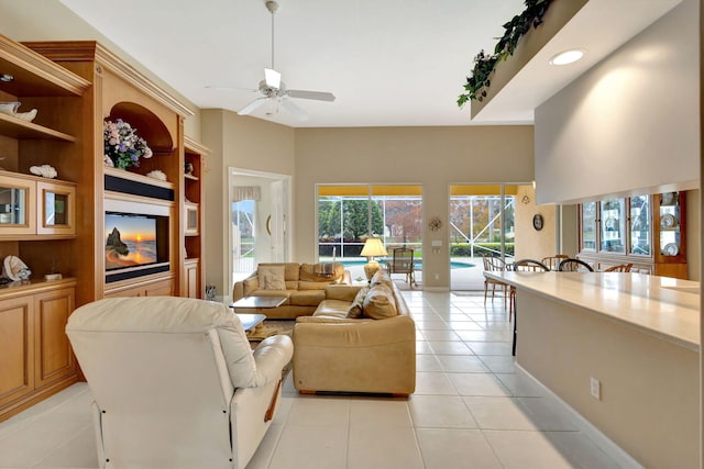 tiled living room featuring built in features and ceiling fan