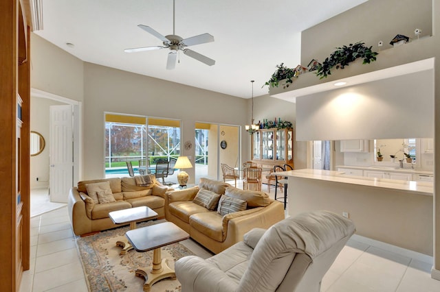 tiled living room featuring ceiling fan and a high ceiling