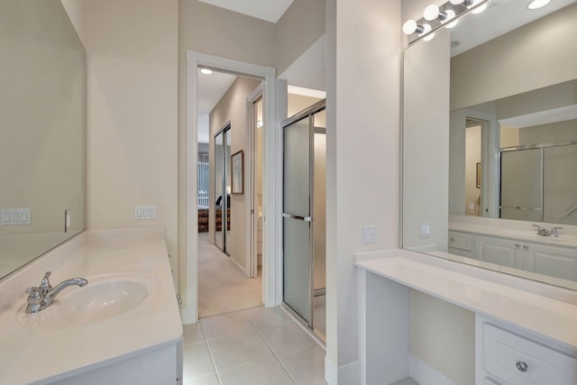 bathroom with vanity, tile patterned flooring, and a shower with door