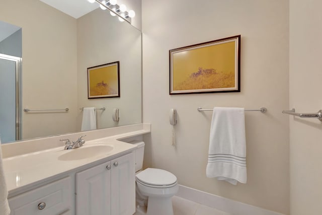 bathroom featuring tile patterned floors, toilet, and vanity