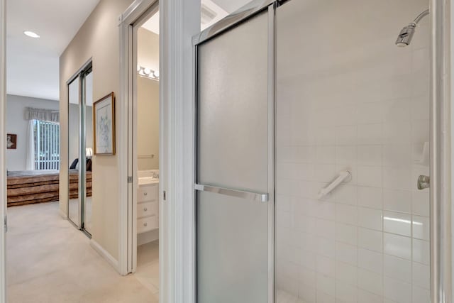 bathroom with vanity and a shower with shower door