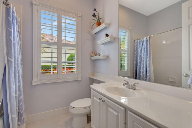 bathroom with vanity, tile patterned floors, toilet, and walk in shower