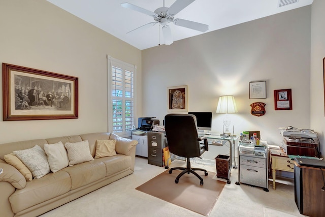 carpeted office space with ceiling fan