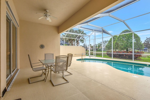 view of swimming pool with glass enclosure and a patio area