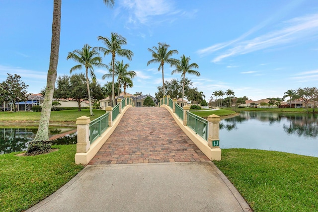 view of community featuring a water view and a yard